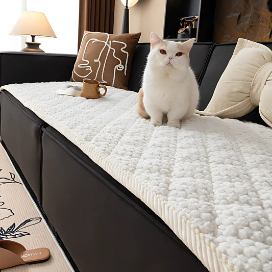 Knit non-slip sofa cover draped over a sofa