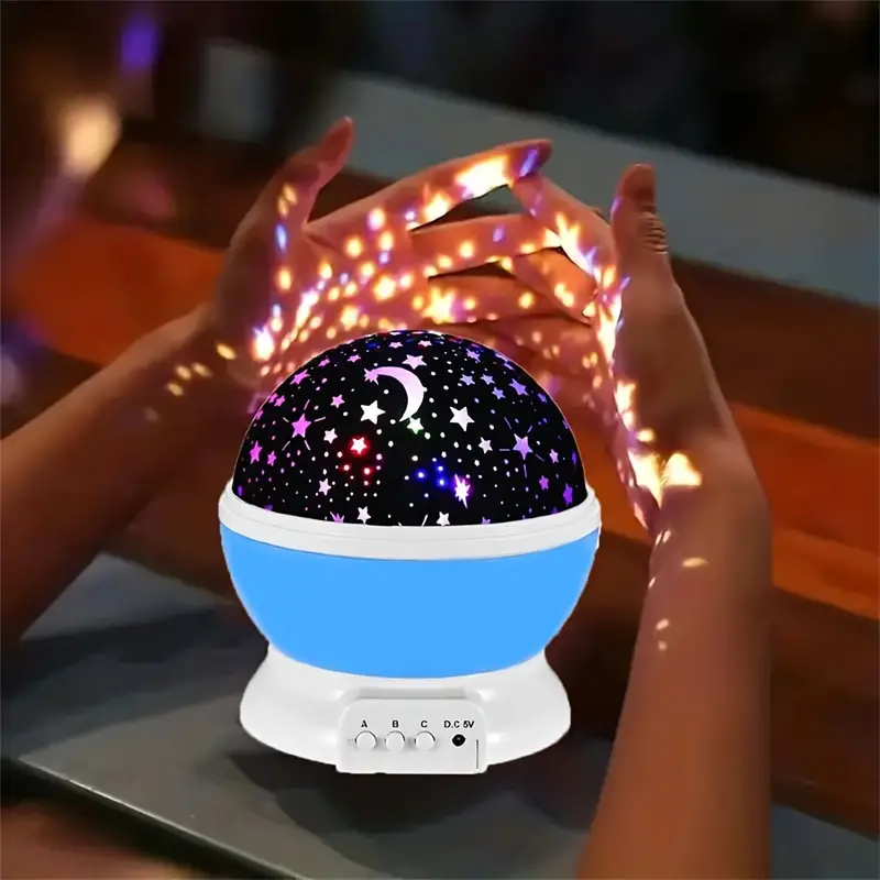 Projector lighting up a bedroom with a starry blue glow