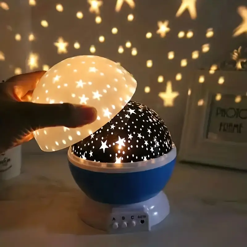 Galaxy projector casting stars and nebula colors on a dark ceiling