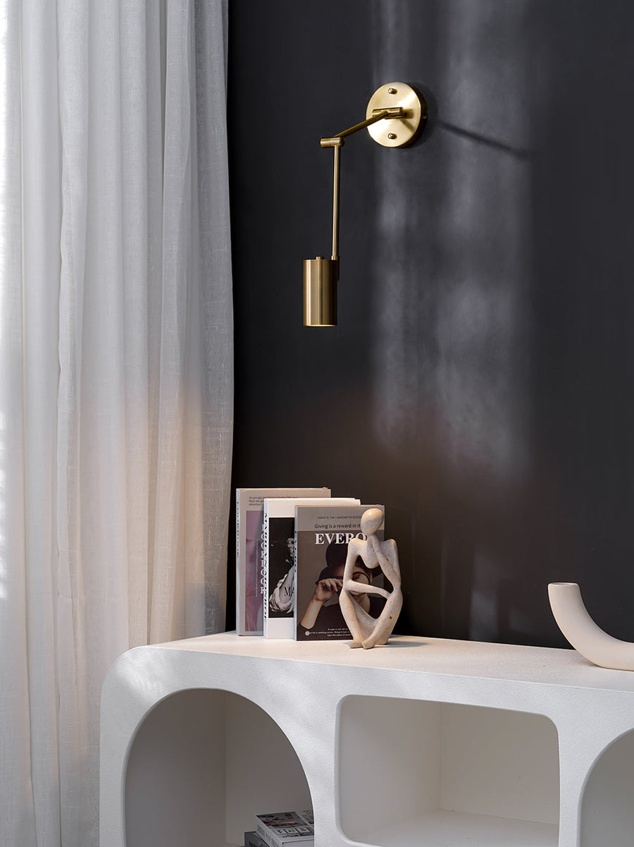 Black wall sconce with warm white light glowing