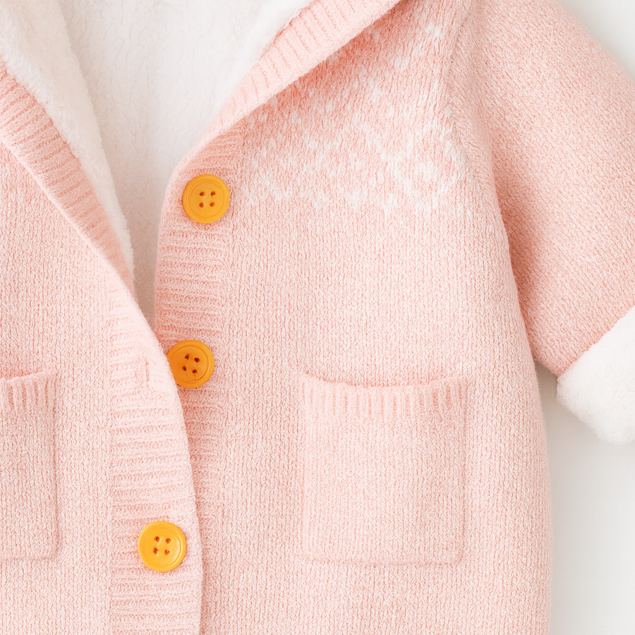 Close-up of the pink knit fabric and soft fleece lining.