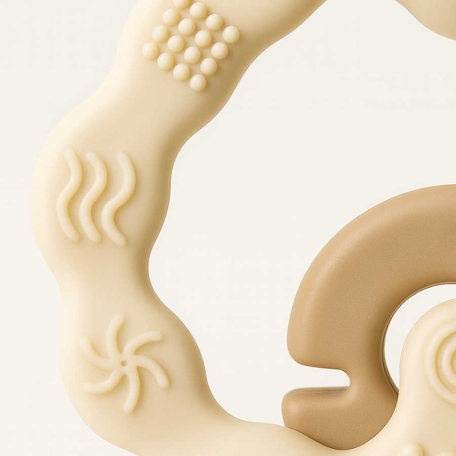Close-up of interlocked silicone teether rings showing raised texture patterns.