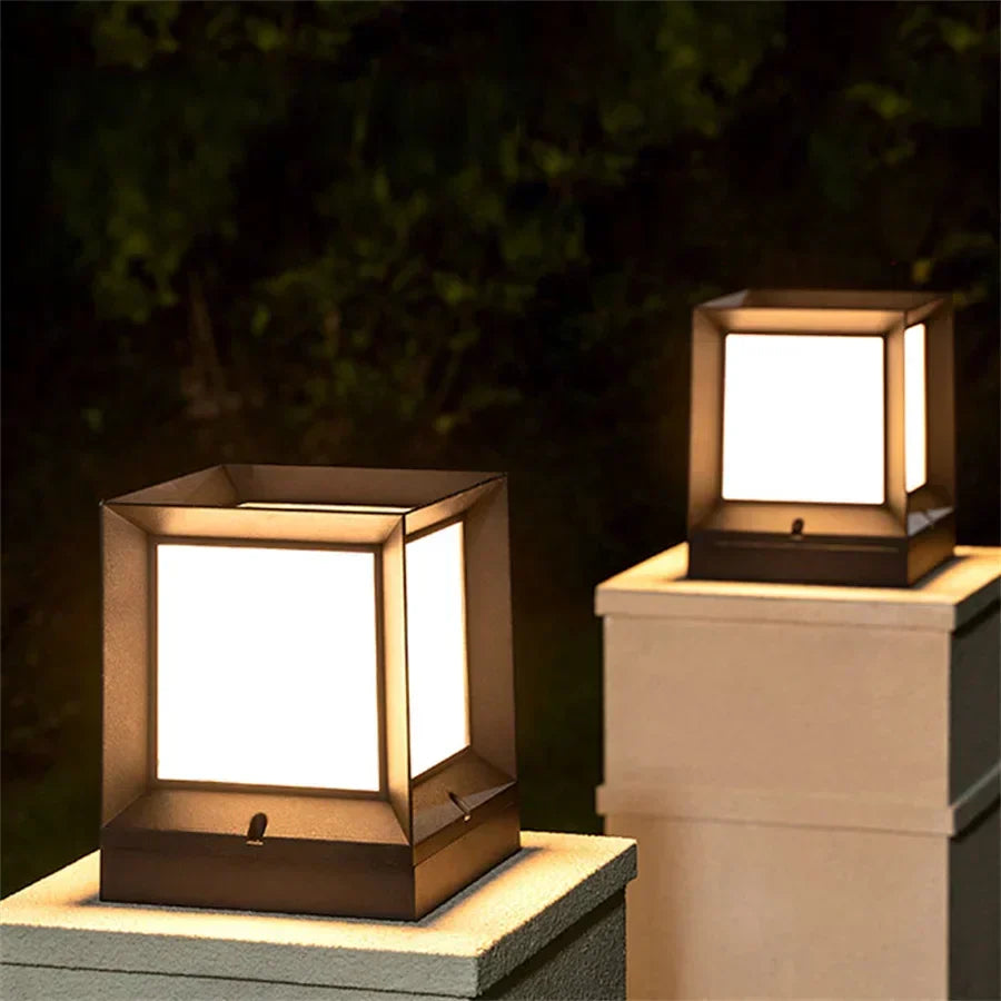 Outdoor pillar gate lamp installed on a garden wall