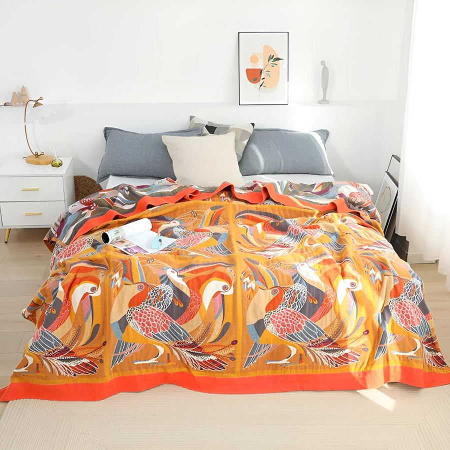 Close-up of the toucan and palm leaf pattern on the throw blanket