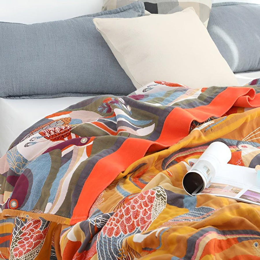 Throw blanket with toucan print laid across a bed