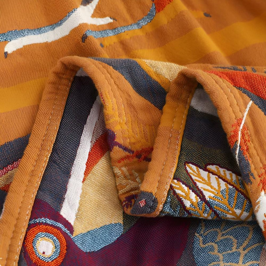 Full view of the tropical toucan print throw blanket