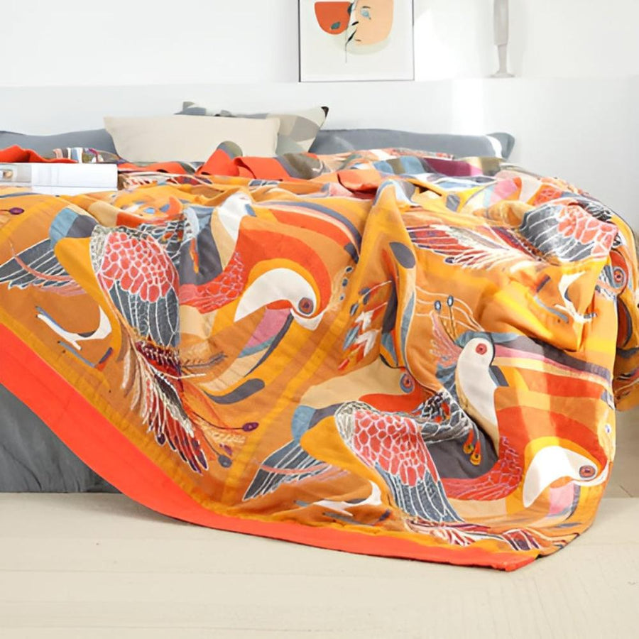 Tropical toucan print throw blanket draped over a sofa