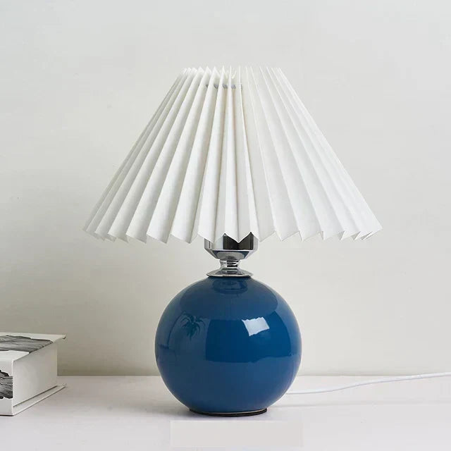 Vintage-style table lamp lit in a bedroom setting