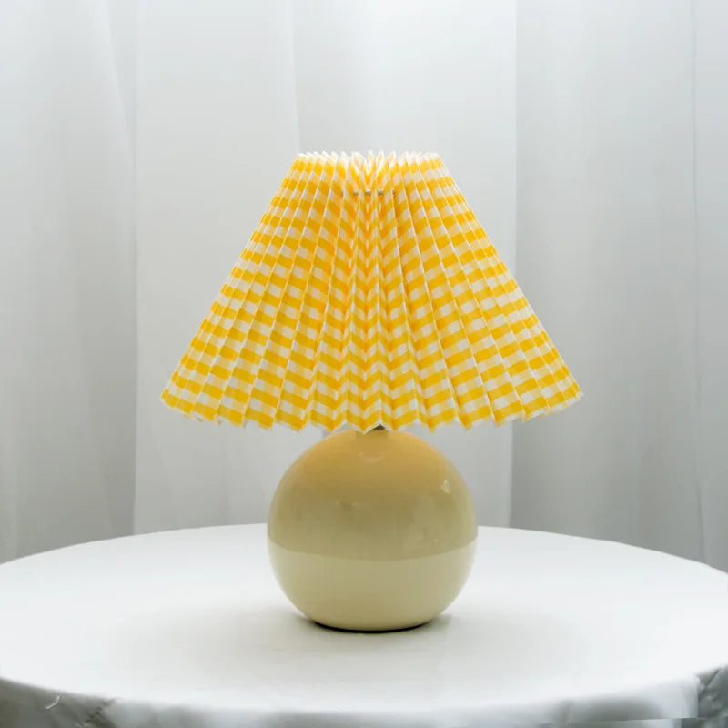 Table lamp shown next to a bed