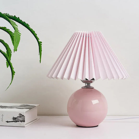 Pleated vintage-style table lamp shown on a nightstand