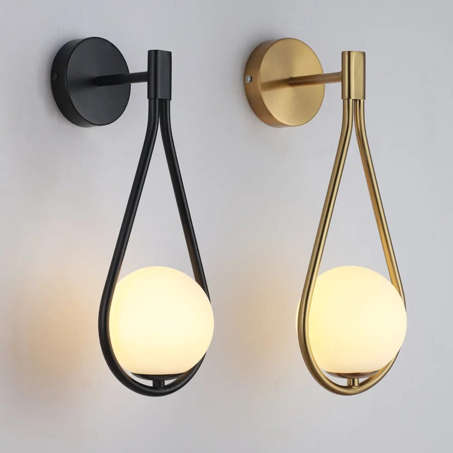 Black wall sconce mounted in a hallway setting.