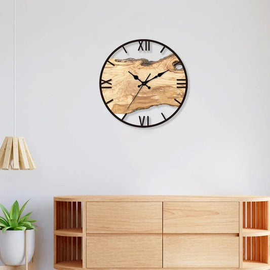 Modern transparent wall clock hanging on a white wall.