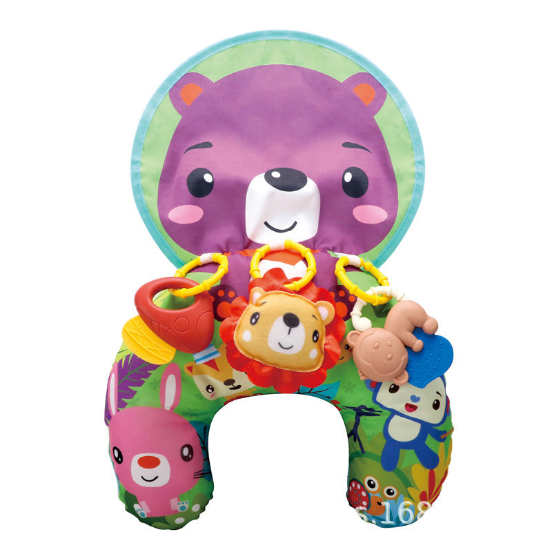 Baby smiling while playing with the pillow's attached toys