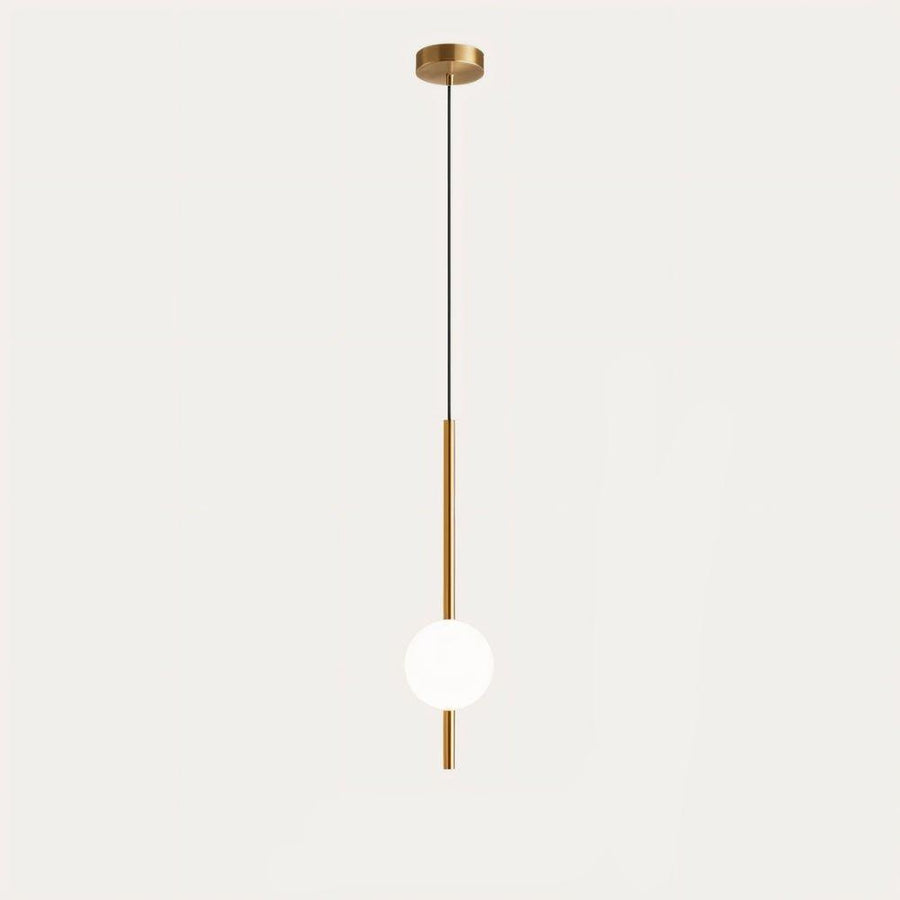Globe pendant light hanging over a bedside table