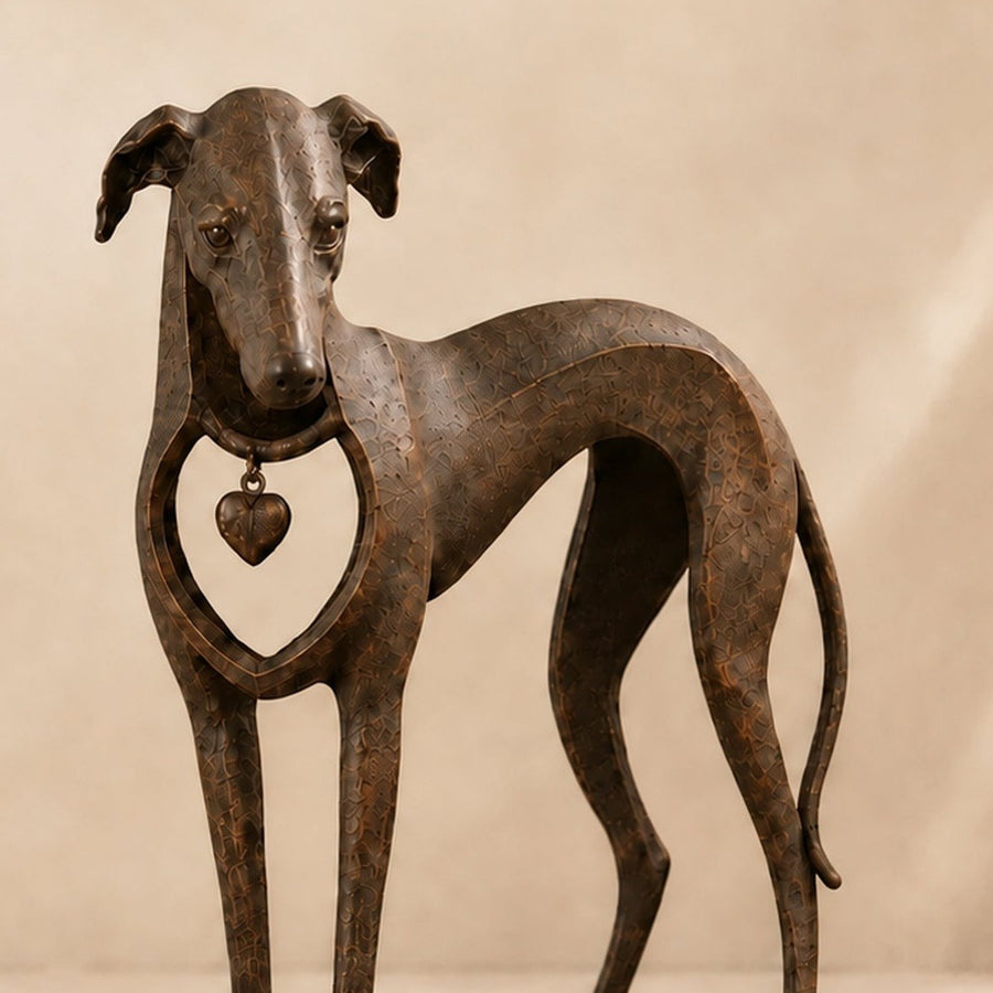 Close-up of textured resin finish and heart charm on dog statue