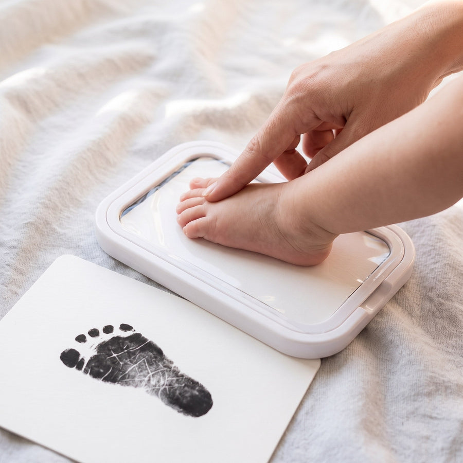A baby's foot gently pressed against the ink pad—skin never touches the ink