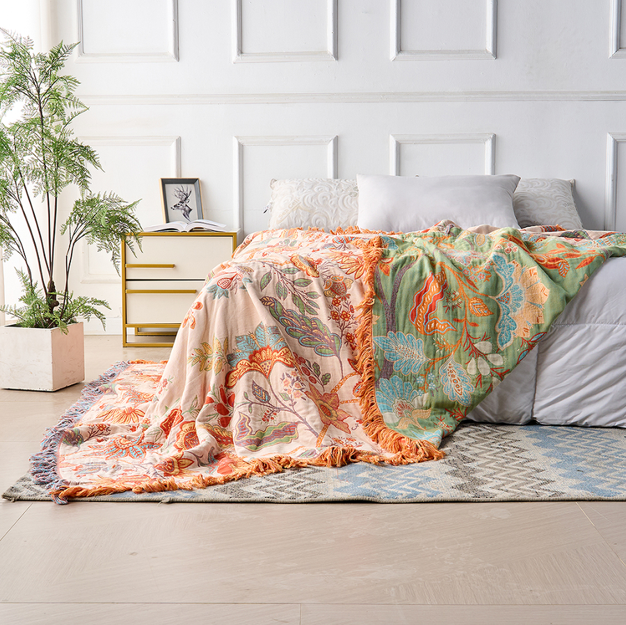 Rustic bohemian floral throw blanket laid across a bed