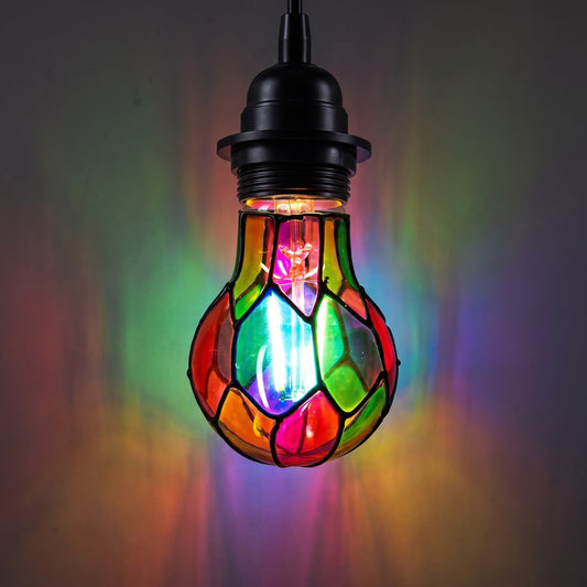 Leaded glass LED bulb lit in a pendant fixture casting rainbow patterns