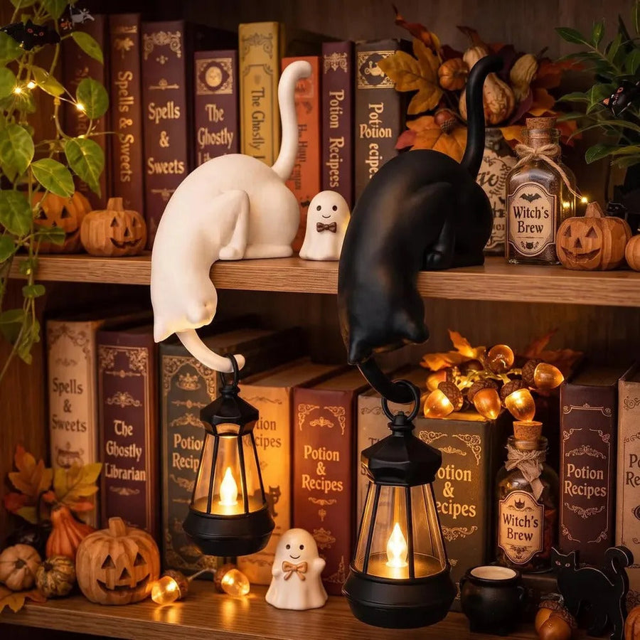 Cat figurine with lantern in Halloween decor – white and black