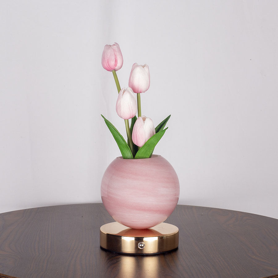 Tulip table lamp on a nightstand in a bedroom