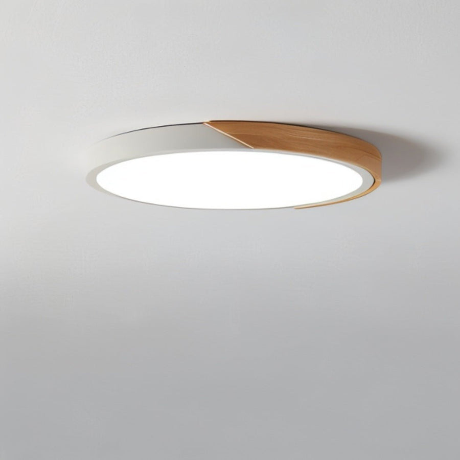 Black round LED ceiling light in a living room setting