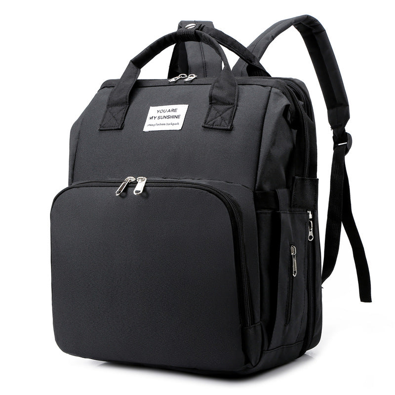 Side view of the diaper bag backpack showing its shape and straps.