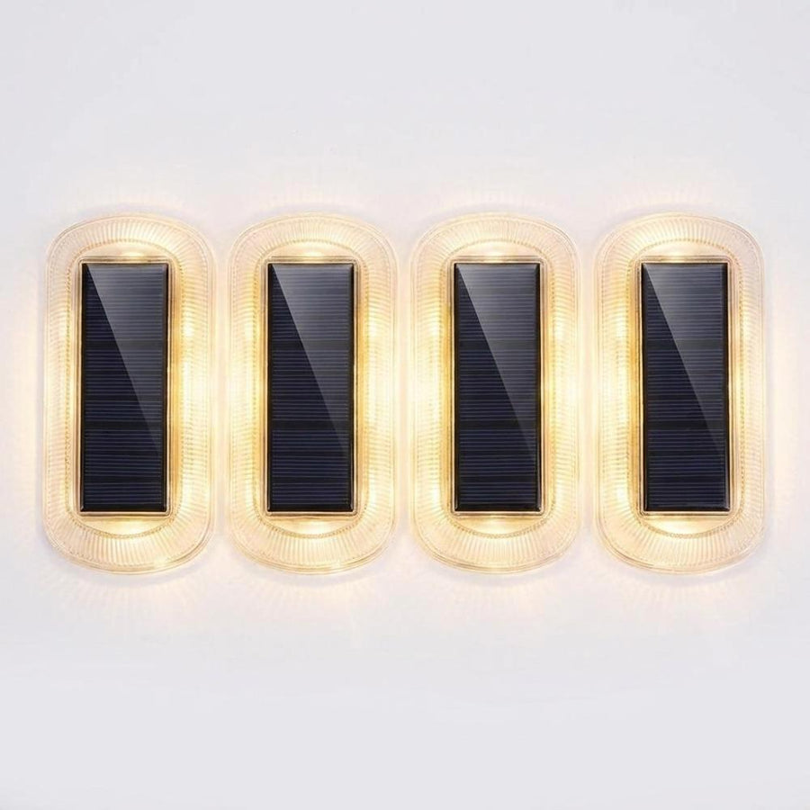 Four solar step lights top-down flat lay showing solar panels