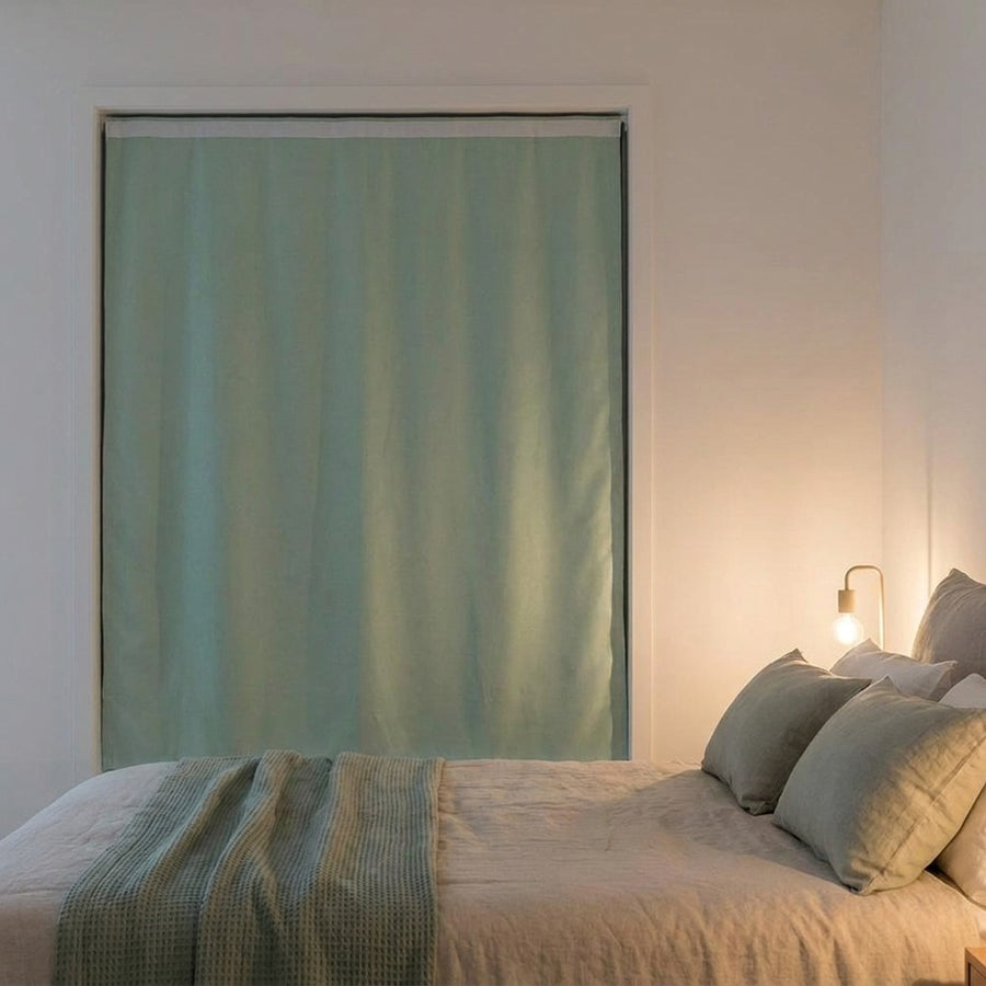 Bedroom with sage green blackout curtain blocking all outside light