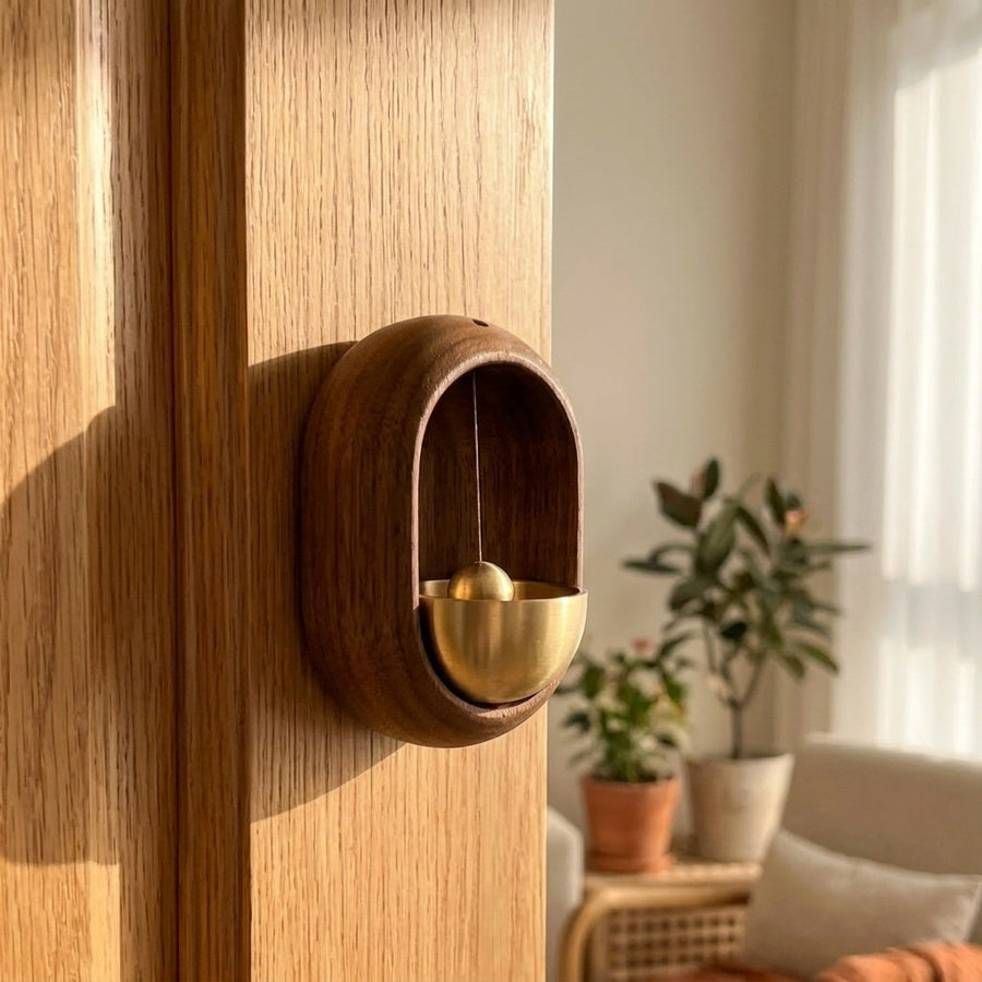 Oval door chime on a light oak door with warm natural light