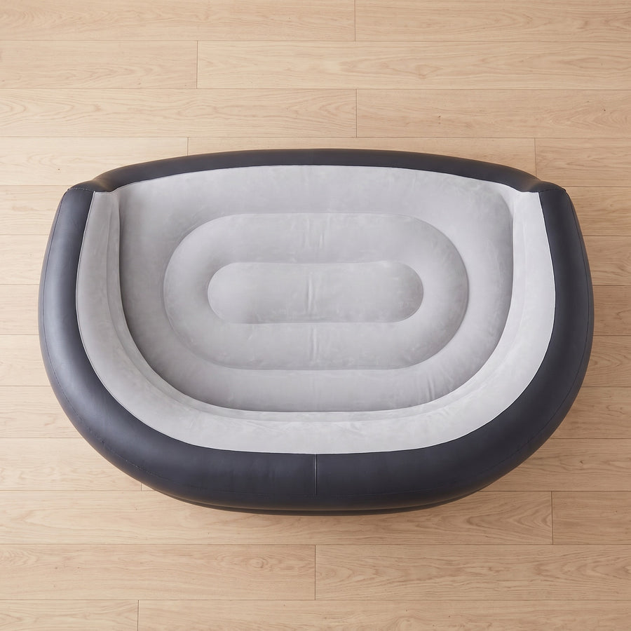 Top-down view showing wide flocked seating area of inflatable sofa