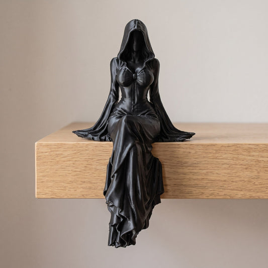 Gothic shelf-sitter statue on a shelf edge with a draped skirt
