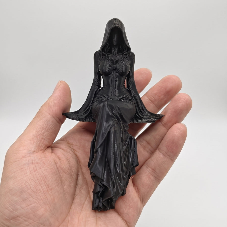 Gothic statue held in a palm showing its compact size