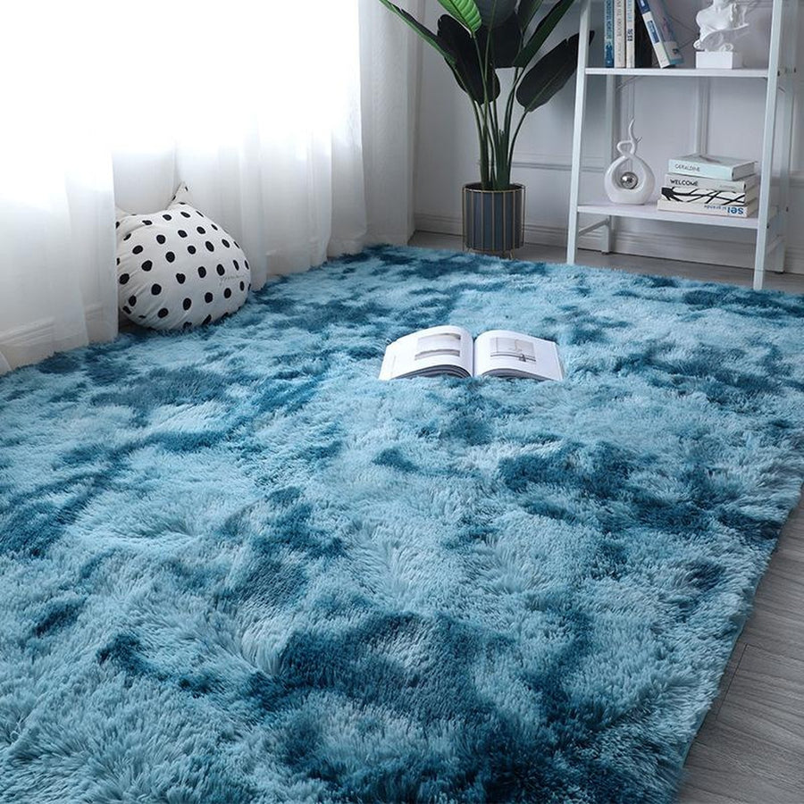 Peacock blue gradient plush rug on gray floor