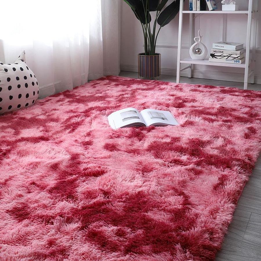 Red gradient shag rug with magazine on top