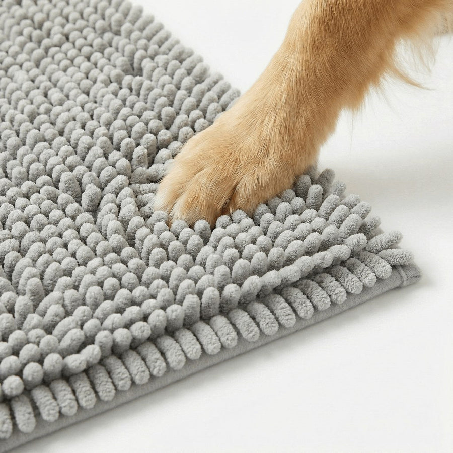 Close-up of a light gray chenille hallway mat with a dog's paw