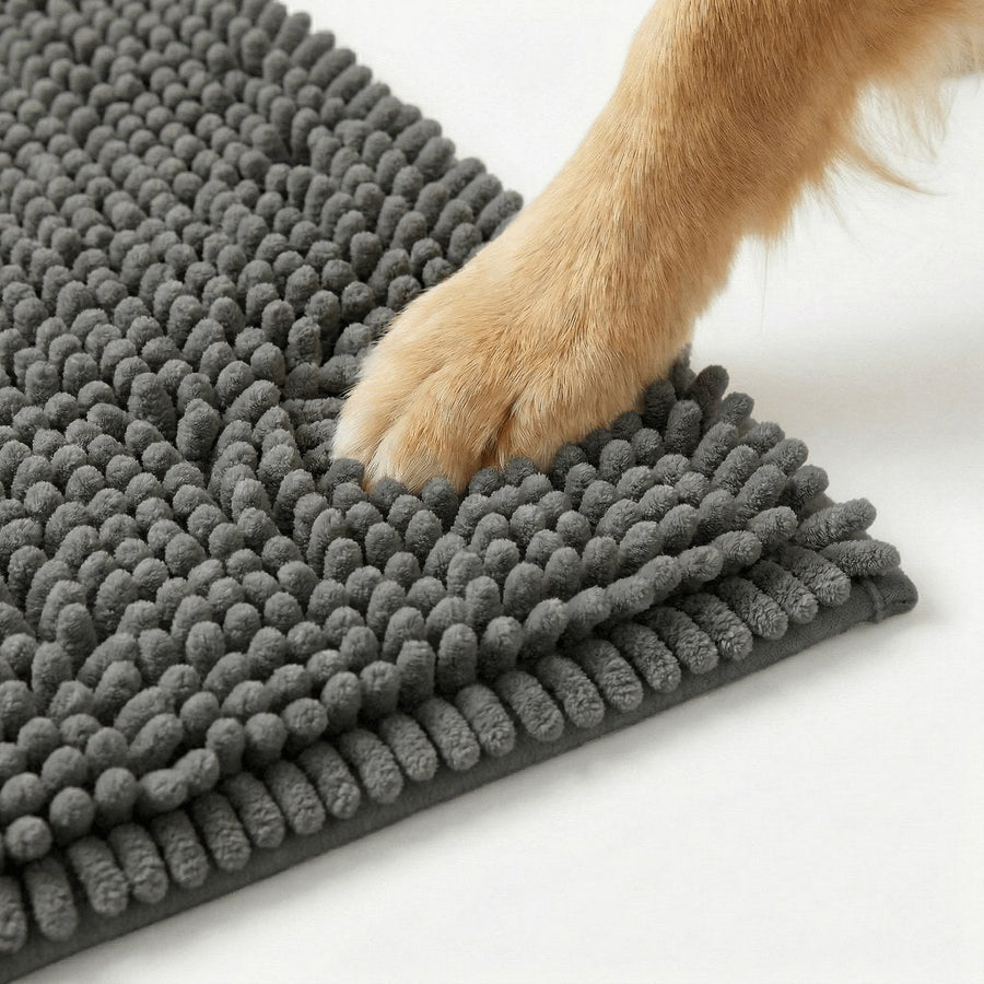 Close-up of a dark gray chenille hallway mat with a dog's paw