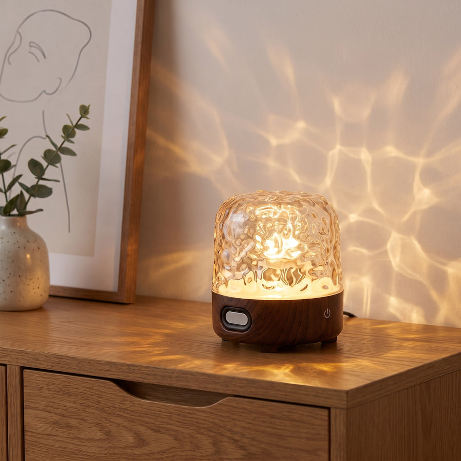 Havie Lamp with a dark walnut base glowing on an oak sideboard, casting water-ripple light on the wall