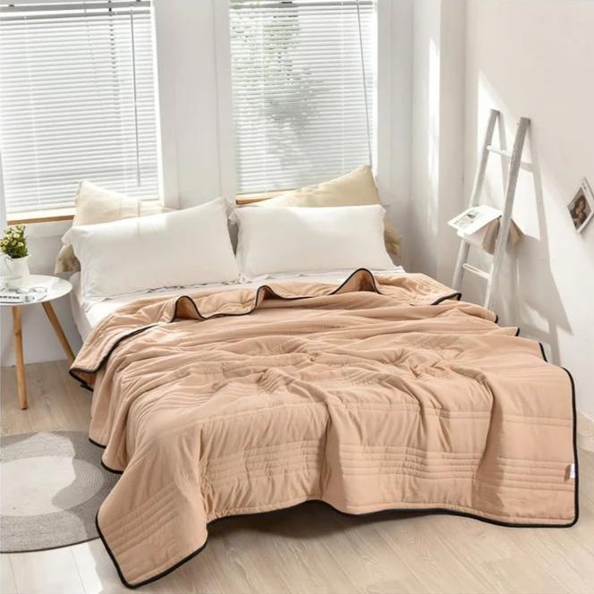 Cooling blanket draped over the end of a bed