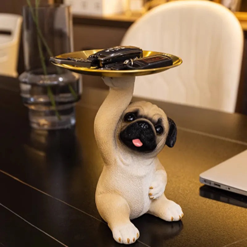 Decorative pug statue with a gold tray for key storage in an entryway