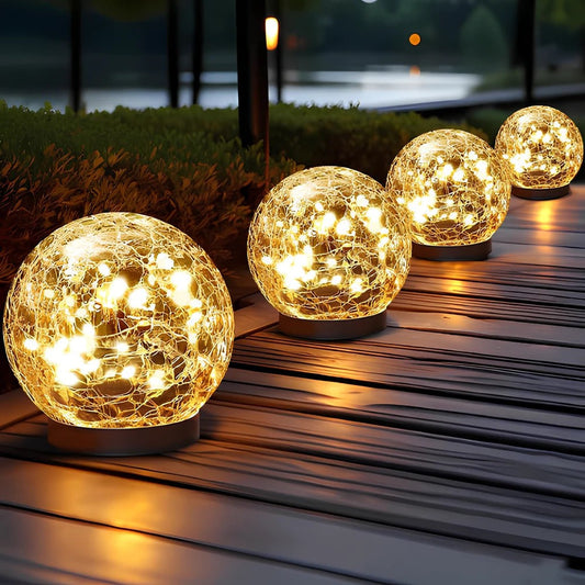 Solar globe lights along a walkway on a wood deck