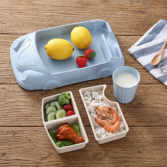 Blue car-shaped kids meal set with inserts on a wooden table