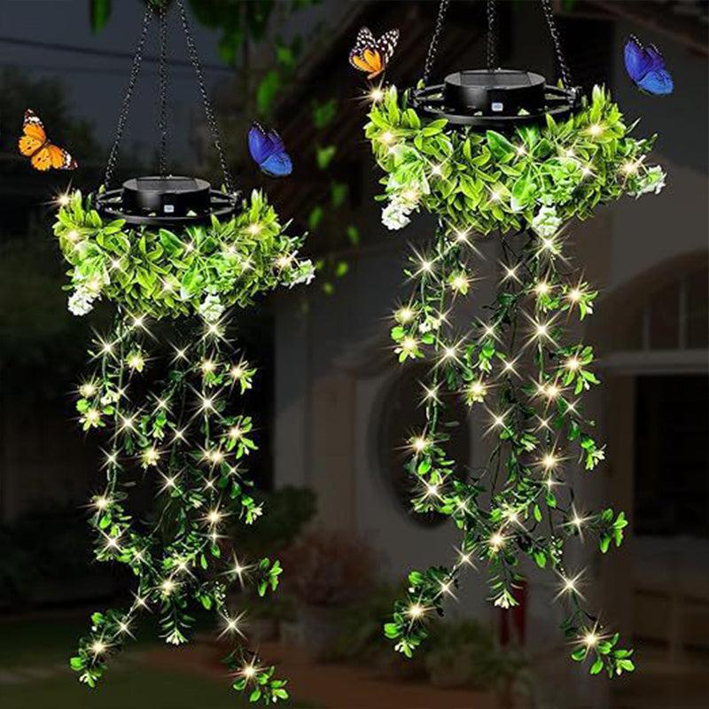 Two hanging solar lanterns with ivy glowing in the evening