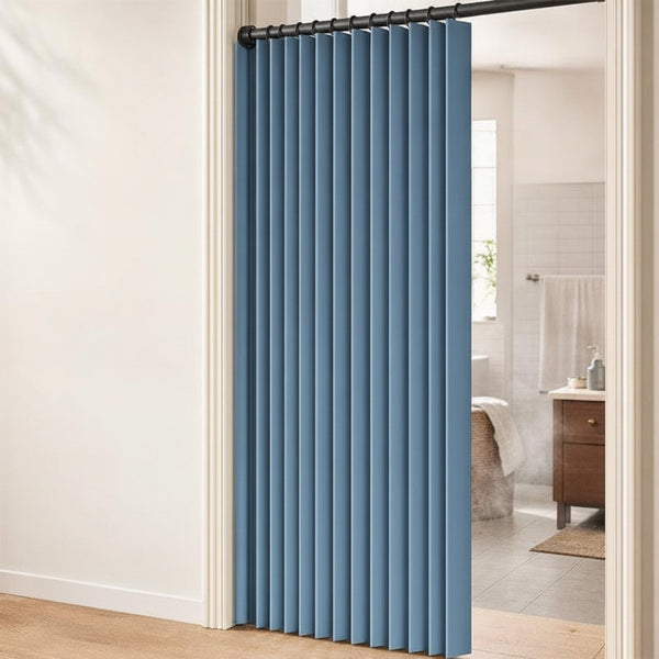 Blue accordion door curtain hung in doorway leading to bathroom