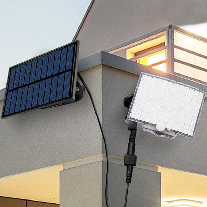 Solar light mounted on a house wall with a separate solar panel.