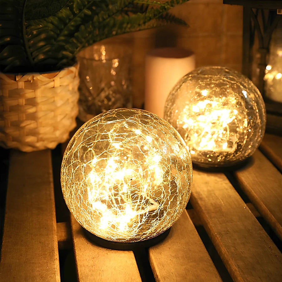 Crackle glass solar globe glowing warmly on a table