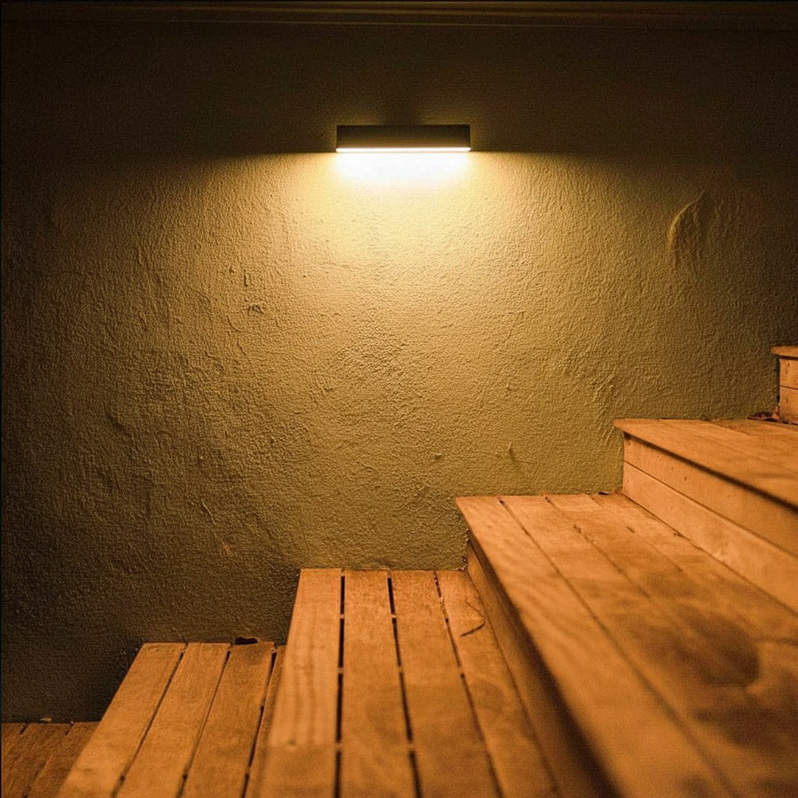 Solar wall light lit up on outdoor stairs