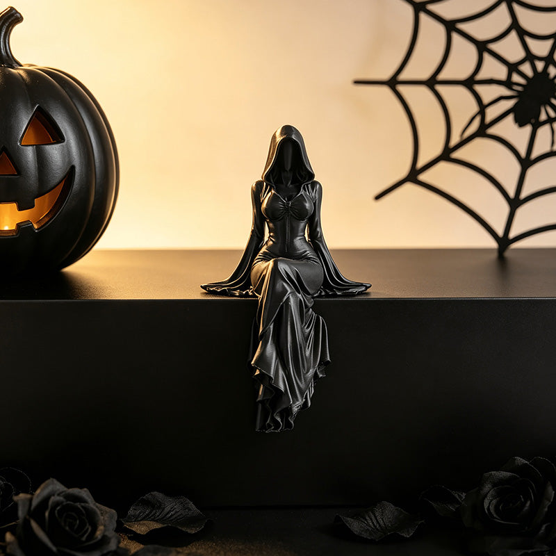 Gothic figure with Halloween decor, pumpkin, and spiderweb