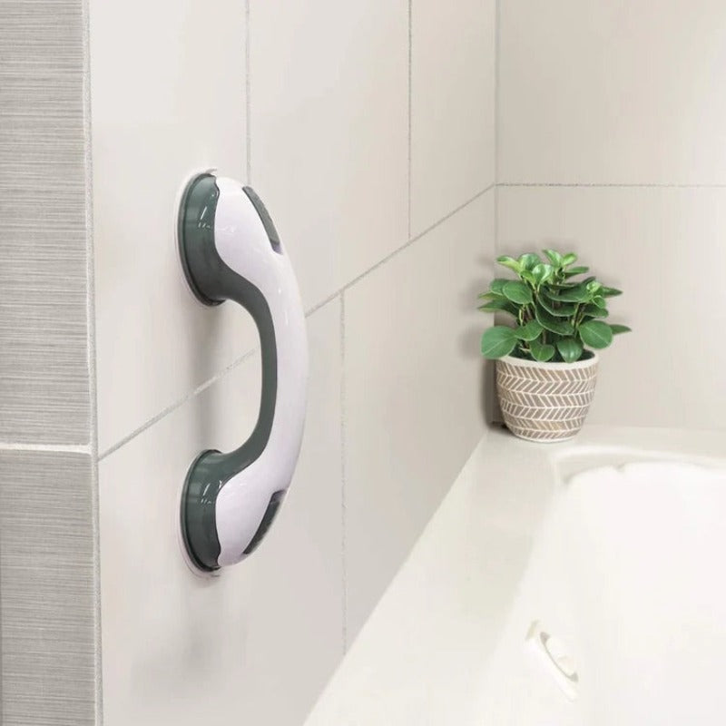 Suction cup handle mounted on bathroom wall by the tub