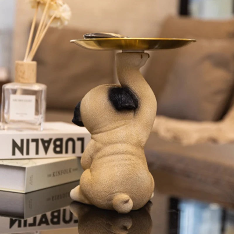 Back view of a pug statue with a decorative tray