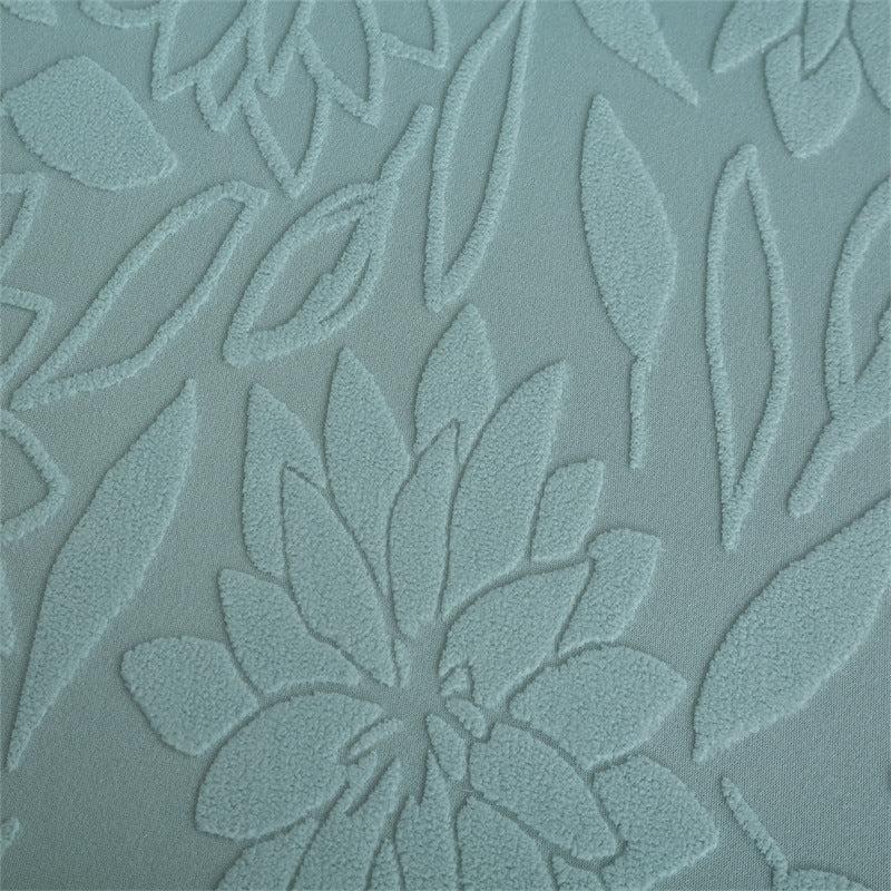 Embossed floral jacquard weave texture closeup on light blue fabric